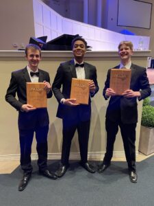 Sam, Daniel, and Noah holding the first place plaques