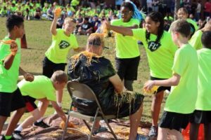 Students dumping spaghetti on head of head of school